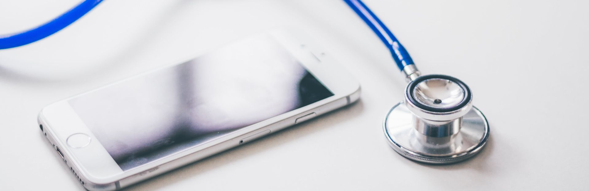 Silver Iphone 6 Near Blue and Silver Stethoscope